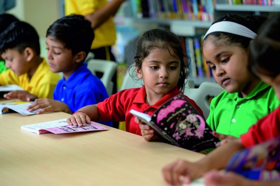 Students reading together at a table in the library