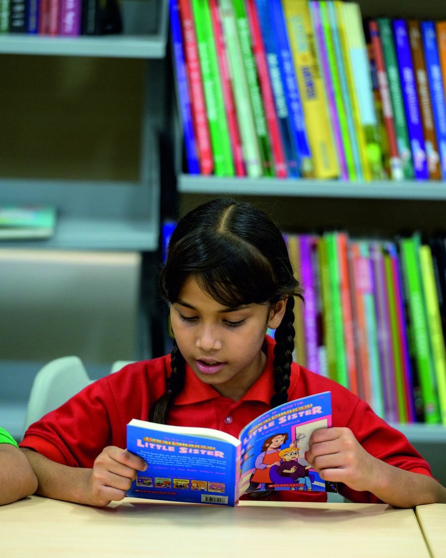 A student reading a book in the library