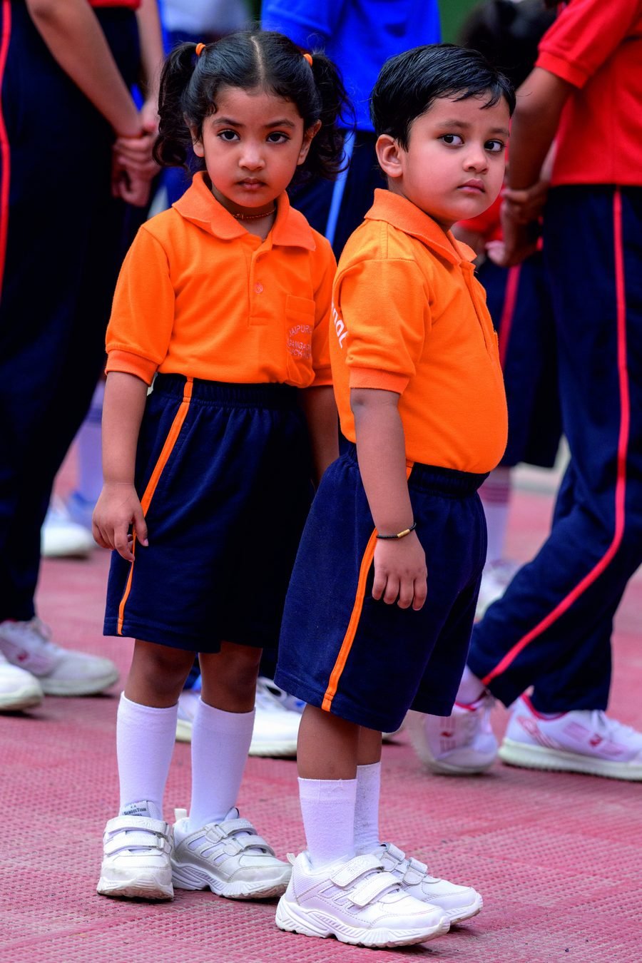 Two young students in the school's house-colour uniform